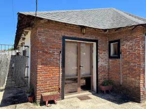 a brick building with a sliding glass door at Apartamento Lomas de Solymar in Ciudad de la Costa