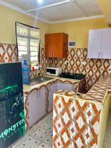 a kitchen with a counter top in a room at palm ridge apartment Diani beach in Diani Beach