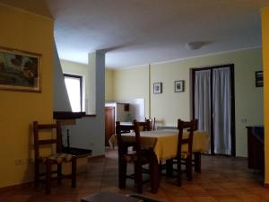 a kitchen and dining room with a table and chairs at La Macina di Bettona in Bettona