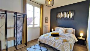 a bedroom with a bed and a window at Le Petit Jacobin - City center in Beauvais
