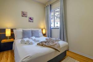 a bedroom with a bed with towels on it at Vilamar- Madeira Inn Group in Calheta