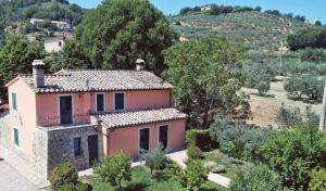 an image of a house with a hill in the background at La Macina di Bettona in Bettona