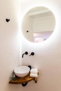 a bathroom with a sink and a mirror at Ryous Mykonos in Mikonos