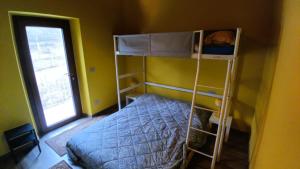 a bedroom with two bunk beds and a window at Ospitalità Adocentyn in Guinadi
