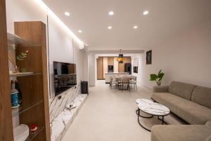 a living room with a couch and a table at Private Villa Ksamil in Ksamil