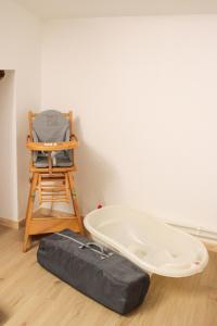 a room with a white wall and a chair and a mattress at Gîte des forgerons in Sainte-Ouenne +17 photos
