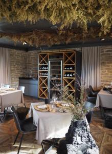 a dining room with tables and chairs and wine racks at Taju Resort in Manniva