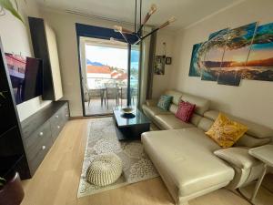 a living room with a couch and a table at Apartment Zoe in Tivat