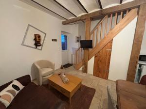 a living room with a couch and a table at La maison du colombophile in Neuville-sur-Ailette