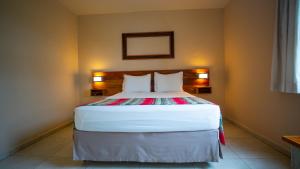 a bedroom with a large bed with two pillows at Meu Hotel Boituva in Boituva +170 photos