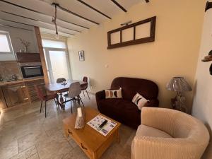 a living room with a couch and a table at La maison du colombophile in Neuville-sur-Ailette