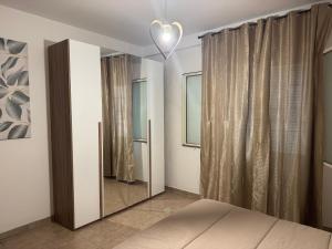 a bedroom with a mirror and a heart light at Civitavecchia Port in Civitavecchia