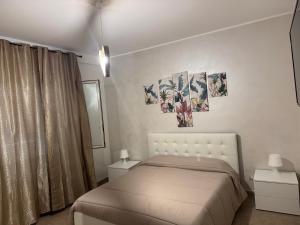 a bedroom with a bed and two paintings on the wall at Civitavecchia Port in Civitavecchia