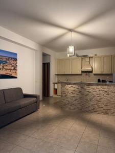 a living room with a couch and a kitchen at Civitavecchia Port in Civitavecchia