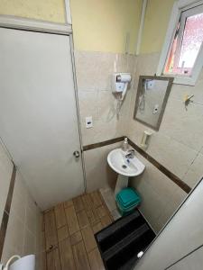 a small bathroom with a sink and a shower at Hostal JV CABAÑA in Nogales