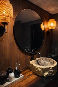 a bathroom with a stone sink and a mirror at Slava Spa Relax House in Nakskov +19 photos