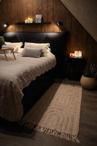 a bedroom with a large bed and a rug at Slava Spa Relax House in Nakskov