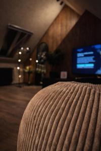 a close up of a bed in a room with a television at Slava Spa Relax House in Nakskov