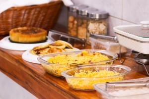 a counter with several dishes of food on a table at Pousada Dom Manuel - Ce in Fortaleza +20 photos