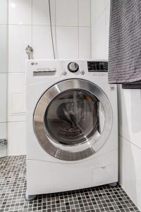 a washing machine in a kitchen with a tile floor at Apartment in the heart of Bergen in Bergen