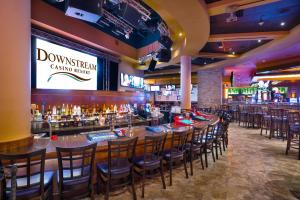 a bar with a row of bar stools at Downstream Casino Resort in Loma Linda