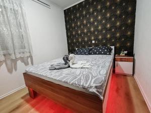 a bedroom with a bed with a large headboard at Vikendica Katarina in Šipovo