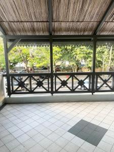 a view of a porch with a fence and trees at Pereybere Beach Home in Pereybere
