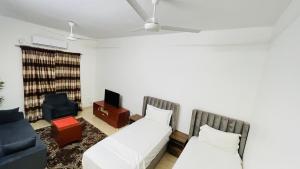 a living room with a couch and a tv at LeLodge Djibouti in Djibouti