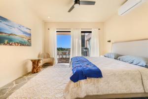 a bedroom with a large bed with a blue blanket at Casa Arroyo Pacific in Todos Santos +47 photos