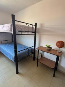 a bedroom with two bunk beds and a table at Hostal Casa Herrera in Guadalajara