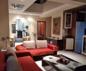 a living room with two red couches and a table at Villa Evi in Volos