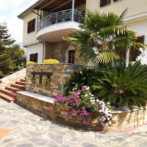 a building with a bunch of flowers in front of it at Villa Evi in Volos