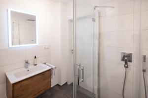 a bathroom with a sink and a shower at Buhlbach, Black Forest Retreat, mit Sonnenterrasse in Baiersbronn +12 photos