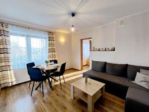 a living room with a couch and a table at Noclegi Sarenka in Murzasichle
