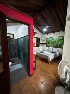 a bedroom with a bed and a large glass doorway at Mono Azul Cahuita in Cahuita
