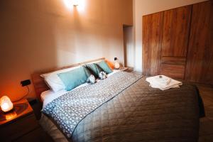 a bedroom with a bed with two stuffed animals on it at Alpine Green Apartment 2026 in Sondrio