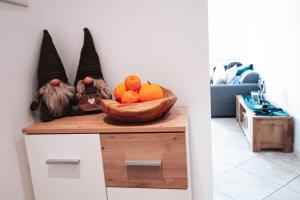 a bowl of fruit on a counter with a bowl of oranges at Alpine Green Apartment 2026 in Sondrio