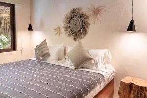 a bedroom with a large bed with pillows at Hábitat Nandá in La Manzanilla +85 photos