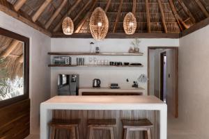 a kitchen with a island in a room at Hábitat Nandá in La Manzanilla