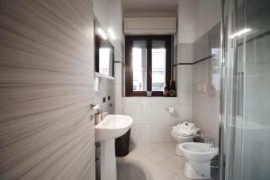 a bathroom with a sink and a toilet at Alpine Green Apartment 2026 in Sondrio