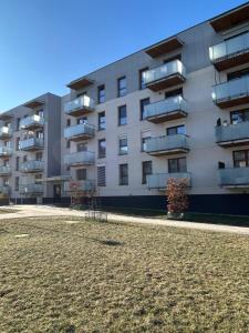 an apartment building with a playground in front of it at Apartament Dobrzec in Kalisz