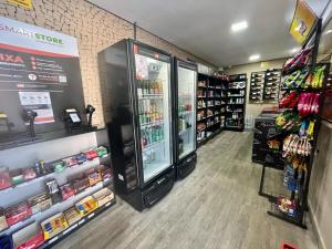 a grocery store aisle with a refrigerator in a store at Crystal Place Flat 509 in Goiânia
