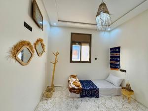 a bedroom with a bed and a window and mirrors at Surf Apartment in Tamri Rooftop Local Experience in Tamri