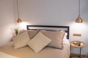 a bedroom with a bed with two pillows and a table at Ca l'Eli Loft in Montblanc