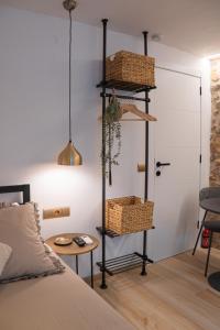 a bedroom with a bed with baskets and a table at Ca l'Eli Loft in Montblanc