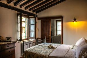 a bedroom with a bed and two windows at Agriturismo Dandelion in Città della Pieve