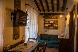 a living room with a blue couch and a table at Agriturismo Dandelion in Città della Pieve