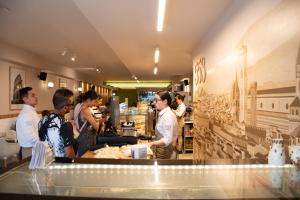 a group of people preparing food in a restaurant at Hotel Santamaria INN in La Ceja