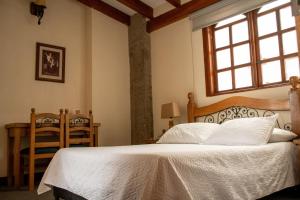 a bedroom with a white bed and a window at Hotel Santamaria INN in La Ceja +42 photos