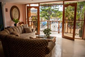 a living room with two couches and a table at Hotel Santamaria INN in La Ceja
